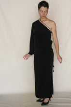 Load image into Gallery viewer, Wearing the Eurie Skirt in 2 Ply Silk Crepe Black and black heels, a person stands against a plain light background, looking down with one arm slightly raised and the other relaxed by their side.