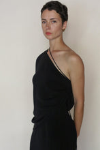 Load image into Gallery viewer, A person with short dark hair and gold hoop earring wears the Eurie Blouse in 2 Ply Silk Crepe Black, standing against a plain light background with a neutral expression.