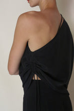 Load image into Gallery viewer, Shown from the back and side against a neutral background, a person wears the Eurie Blouse in 2 Ply Silk Crepe Black—an asymmetrical top with ruched detailing and an adjustable side drawstring.