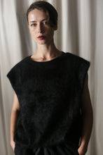 Load image into Gallery viewer, In front of a neutral curtain backdrop, a person with short, dark hair wears the stylish Salento | Black structured vest. They look calm as their hands rest casually in their pockets.