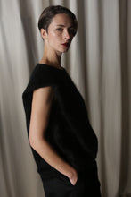 Load image into Gallery viewer, A person with short hair is seen in profile wearing a Salento | Black structured vest over a sleeveless black top, hands in pockets, against a neutral, softly-lit background.