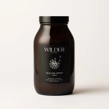 Load image into Gallery viewer, A dark brown jar with a black label prominently displaying the &quot;Wilder Botanics&quot; brand name. The label reads &quot;Healing Spirit Soak,&quot; highlighting that it is calendula-infused with rose geranium, vetiver, and enriched with pink Himalayan salts. This 100% natural product stands against a light background.