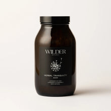 Load image into Gallery viewer, A dark brown glass jar with a black lid is labeled &quot;Herbal Tranquility Soak&quot; from Wilder Botanics. The label highlights that the soak is infused with lavender and soothing chamomile, complemented by Epsom salts and French green clay, ensuring a 100% natural blend. The background is plain and white.