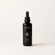 Load image into Gallery viewer, A dark-colored dropper bottle labeled &quot;Recovery Night Oil&quot; stands against a plain white background. The minimalist packaging features a floral design and text in white, highlighting its blend of rose oil and phytonutrients.