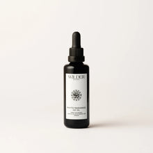 Load image into Gallery viewer, A small black dropper bottle labeled &quot;Wilder Botanics&quot; containing Phyto Radiance Day Oil, infused with Prickly Pear seed oil. The label features a geometric floral design and the bottle stands against a neutral background with soft shadows.