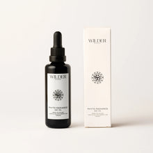 Load image into Gallery viewer, A dropper bottle labeled &quot;Phyto Radiance Day Oil,&quot; enriched with Arctic Blackcurrant seed oil, sits next to its matching box. The bottle is matte black with a white label and black text, while the box is white with the same geometric design and text. The background is plain white.