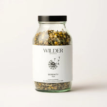 Load image into Gallery viewer, A glass jar labeled &quot;Serenity Tea&quot; filled with loose herbs. The label, adorned with a floral design, states &quot;Calm &amp; Support&quot; and &quot;All Organic Whole Loose Herb.&quot; This organic infusion in a black-lidded jar is designed to aid sleep and promote calm and serenity against a plain white background.