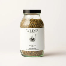 Load image into Gallery viewer, A glass jar of Solstice Tea from Wilder Botanics, featuring a matte black lid and filled with an organic herbal blend of whole loose herbs. The minimalist white label showcases a botanical illustration along with text that reads &quot;Winter &amp; Spring All Organic Whole Loose Herb,&quot; making it ideal for enhancing immunity.